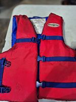 Red life jacket with blue straps and round Buoy-O-Boy crest