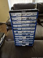 Front view of one organizer showing blue frame, clear drawers and labels