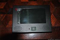 Front view showing 7-inch screen, speaker grilles, sensor