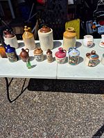 Overview of table showing full assortment of jugs, crocks and decanters