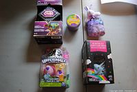 Group shot showing Merge Cube, bath slime, plush bunny sachet, Hatchimals 2-pack and unicorn string lights