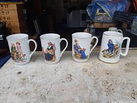 Front view of first four mugs showing different Norman Rockwell scenes