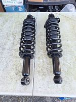 full view of both coilover shock absorbers laid flat