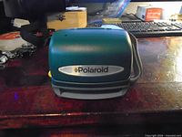 Front closed view showing Polaroid logo and green teal body