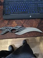 Full knife showing curved blade and sculpted handle