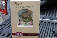 Front of boxed musical water globe showing product through window