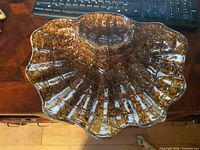 Top view of large clamshell chip and dip tray showing scalloped rim and central well