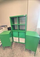 Bookshelf flanked by two metal cabinets, bins visible