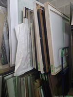 Carts loaded with framed artwork showing two-tier rail system and casters