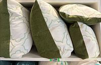 Four pillows in storage cubby showing side panels