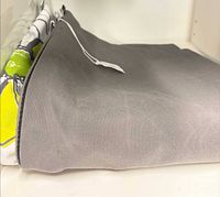 Grey and partial floral cushion covers showing Sunbrella fabric and zipper tag