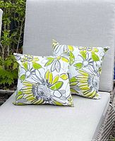 two floral cushions on grey lounge chair