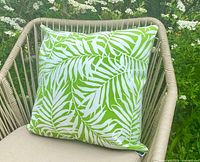 Cushion displayed on chair showing palm pattern and color