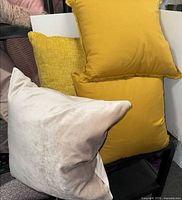 Stack of four pillows showing colors and textures