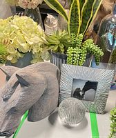 overview of all items: horse bust, faux plants, frame, glass orb