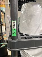 Close view of post and shelf corner of black plastic unit