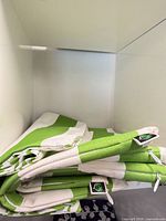 Stacked green and white striped cushion covers folded