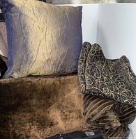 Group of cushions and covers—shimmer cushion, brown velvet cushion, corduroy pillow, folded patterned cover