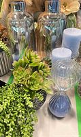 Group shot showing vases, hourglass, candles, holders, faux plants