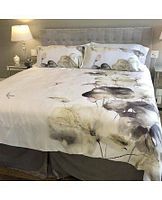 Floral duvet cover and shams on king bed