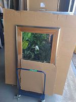 Front view of cart loaded with framed art (art not included) showing blue frame, handle and casters
