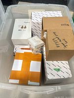 large plastic tote containing multiple sealed boxes