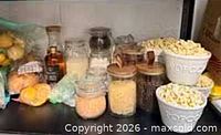 Overall view showing faux food bags, jars and popcorn bowls on shelf
