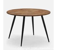 Stock image of assembled round wood dining table with black legs