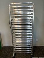 front view of aluminum bakers rack loaded with trays