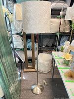 Full view of floor lamp showing shade, pole, wood accent, and base