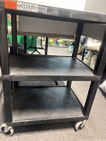 Full view of three-shelf black plastic cart