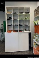 Full front view of cabinet with upper cubby shelf, contents removed for scale