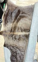 Full view of cowhide rug showing natural outline and coloration
