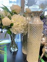 Arrangement and silver mosaic vases grouped together
