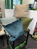 Group of four decorative pillows stacked