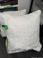 Front view of one pillow showing quilted floral design