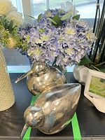 Arrangement and both silver bird figurines together