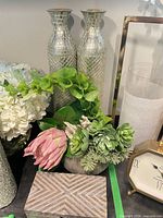 Lot overview showing faux floral arrangement, pair of silver mosaic vases, striped wood box
