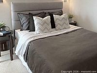 Bed dressed with grey GlucksteinHome duvet and shams