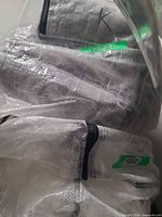 Grey quilted coverlet and shams inside packaging labelled with size K
