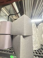 Stacked square tapered grey shades and adjacent cylindrical shade