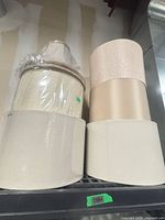 Two nested shades at left, three stacked shades at right on shelf