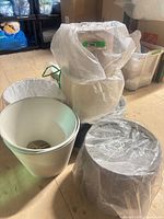 group of lamp shades, various sizes and colours, wrapped