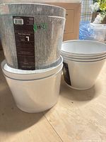 Stacks of grey and white Allen + Roth drum lamp shades