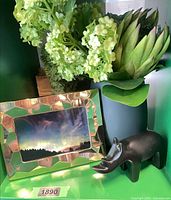Faux floral arrangement in vase, gold frame, wood rhino