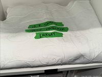 White thick matelasse king shams folded on shelf