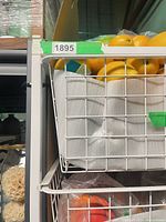 Close view of top wire drawer showing white mesh construction and condition