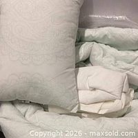 Mint paisley comforter next to white comforter