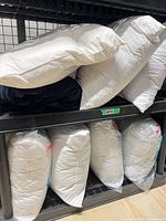 Top shelf with loose white pillow inserts and two navy inserts