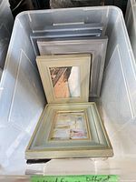 Stack of light blue and grey frames in bin